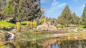 A natural landscape with a pond, trees, and a rock with 'EAGLE CREEK' inscribed.
