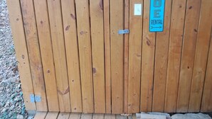 A wooden cabin with a rental sign, a door, and a wooden deck. - Serene Lakefront Cottage Home, relax and enjoy! Walk right to the water. (Westview)