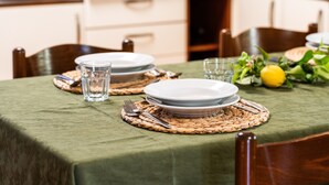 A dining table set with plates, cutlery, and a glass of water.