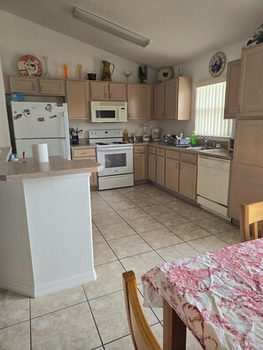 Fridge, stovetop, dishwasher, coffee/tea maker