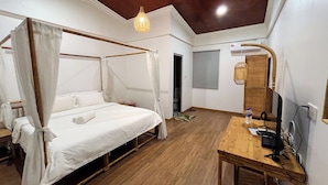 A room with a four-poster bed, a wooden desk with a computer, and a ceiling light fixture. - Titiwangsa Cabin Retreats by uBook (Kuala Lumpur)