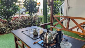 A table set outdoors with a coffee maker, a glass, and a teapot. - Titiwangsa Cabin Retreats by uBook (Kuala Lumpur)