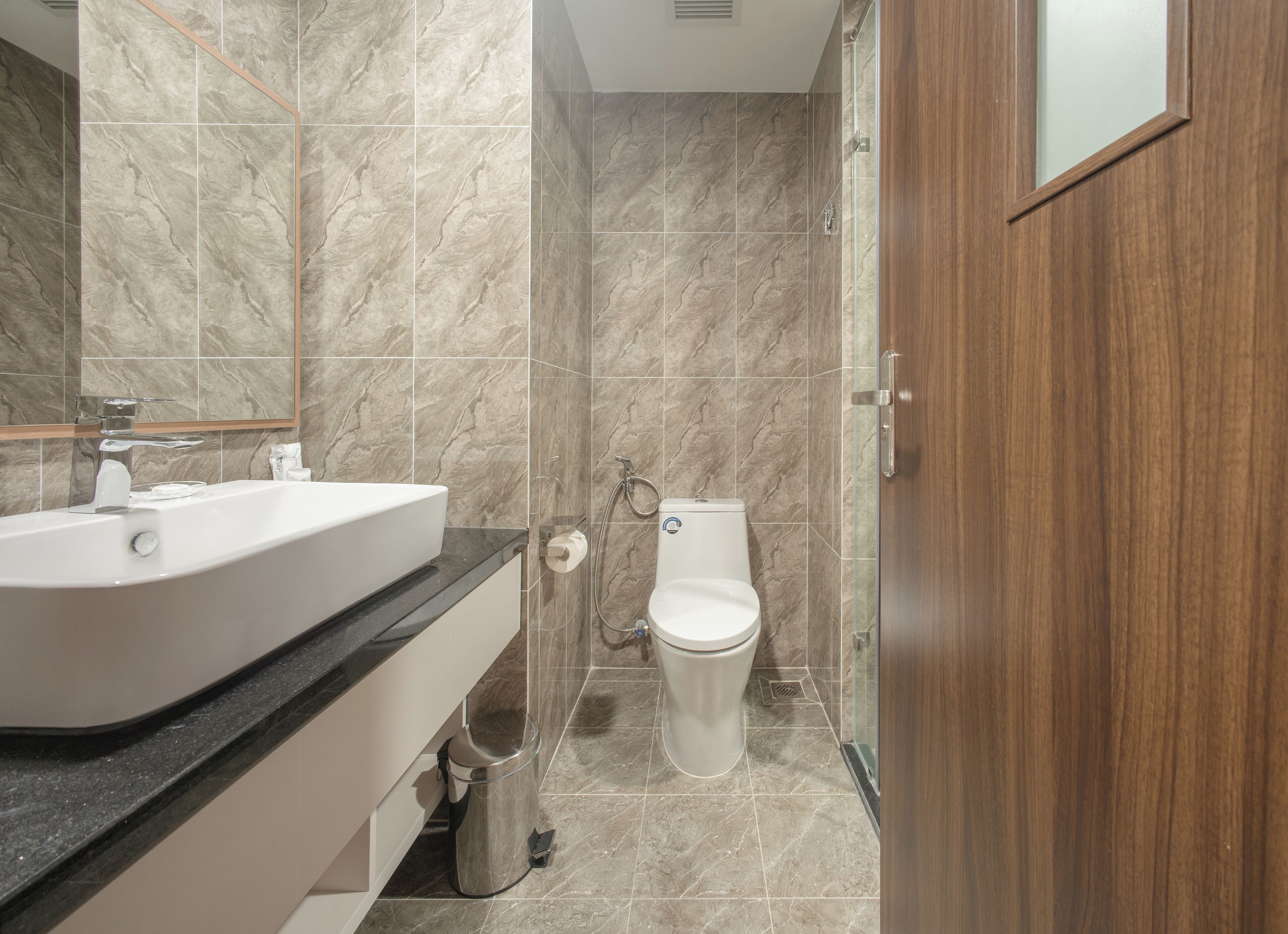 A bathroom with a sink, toilet, and shower.