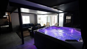 A modern spa area with a hot tub, seating, and a view of the outdoors. - Close to the Beach and 5th Ave! Fun Naples Peaceful Getaway 4U!  (Naples)