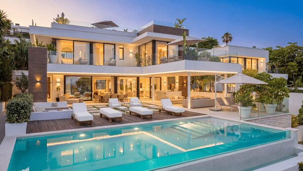 A modern two-story house with a swimming pool, outdoor seating, and lush landscaping. - Villa Almost Heaven by Vacation Marbella (Nueva Andalucía)