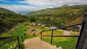 A staircase leading to a scenic overlook with a view of rolling hills and a distant body of water. - Leopard Rock Wilderness Resort Ooty by VOYE HOMES (Ootacamund)