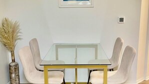 A dining table with four chairs, a vase with pampas grass, and a framed picture on the wall. - New Marina Del Rey 1 BDR Beach / Pool & Hot Tub, Ocean
 (Marina del Rey)