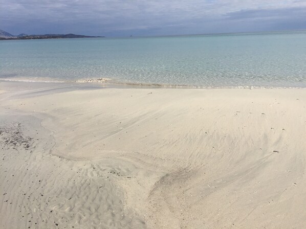 A beach with clear turquoise water and white sand. - AL FARO VINTAGE HOTEL -SPIAGGIA LA CINTA-SAN TEODORO (San Teodoro)