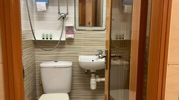 Habitación cuádruple Deluxe | Baño | Zapatillas, champú y papel higiénico