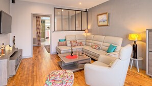 A modern living room with a sofa, armchairs, a coffee table, and a TV. - La belle étape by Interhome (Cherrueix)
