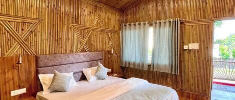 A wooden-themed bedroom with a bed, nightstands, a ceiling fan, and a window with curtains.
