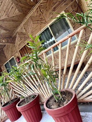 A bamboo structure with potted plants.