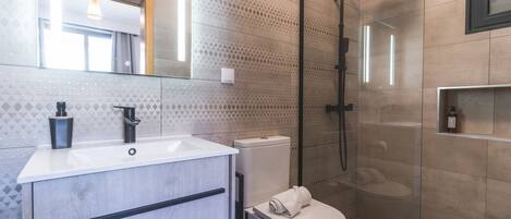 Shower, hair dryer, towels, toilet paper