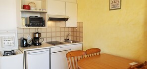 Een koelkast, een oven, een kookplaat, een koffiezetapparaat/waterkoker