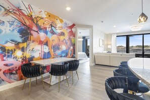Enjoy dining and socializing in this stylish space with a glass-top table and comfortable seating.
