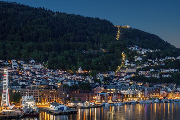 A waterfront cityscape with a prominent bridge, dense residential buildings, and a marina with boats. - Exquisite 2br. apt., impeccable standard, panoramic views of Bergen harbor.

 (Bergen)
