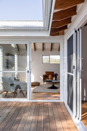A modern interior with a sliding glass door leading to an outdoor deck.