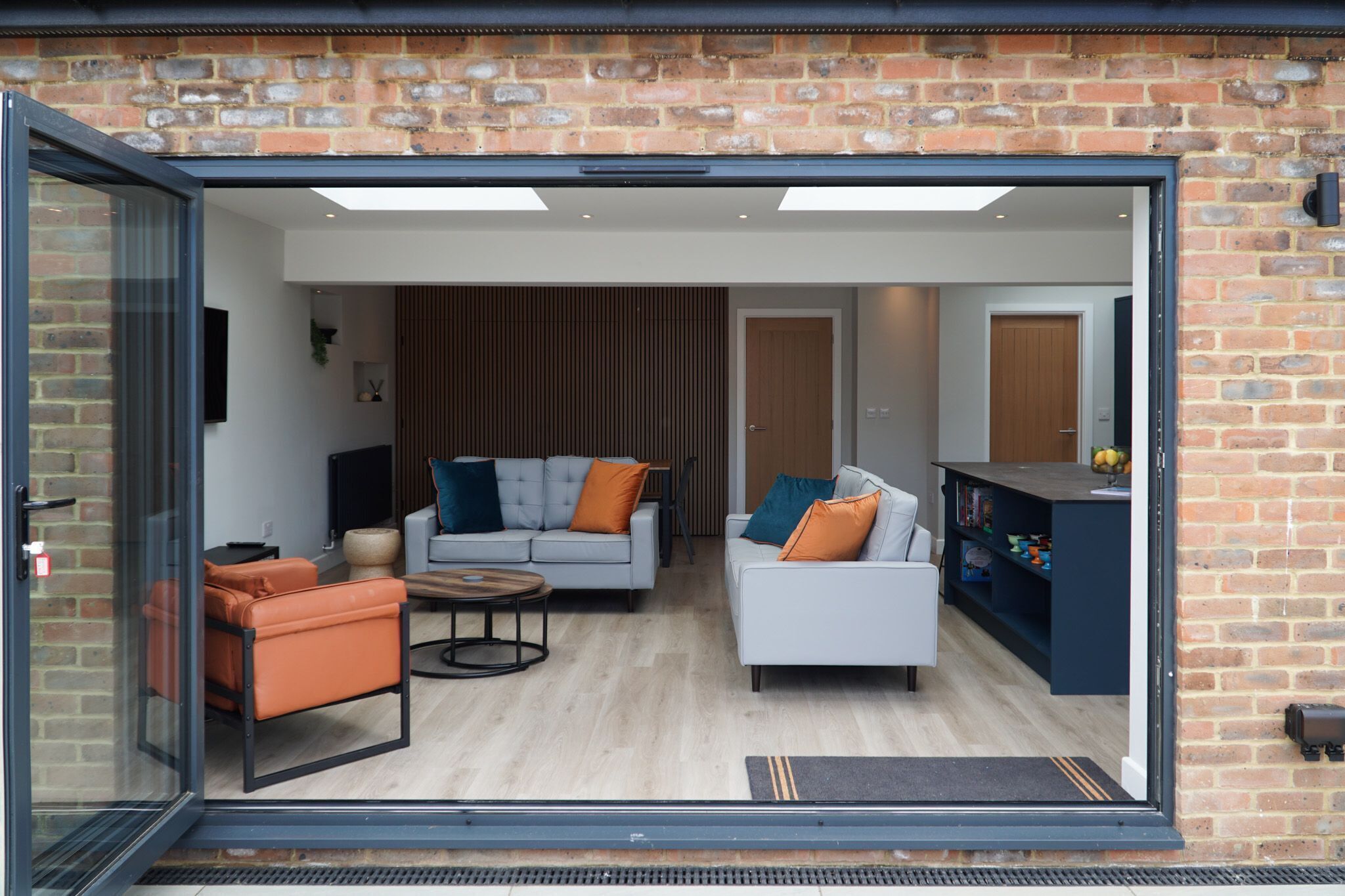 A modern living room with a sofa, armchairs, and a coffee table.