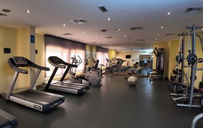A gym with treadmills, elliptical machines, and weightlifting equipment. - Golden Tulip Muscat (Muscat)