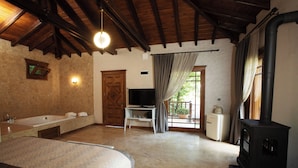 A spacious bathroom with a large bathtub, a wooden ceiling, and a stone floor. - Casa Giallo Managed By Dedeman (Sapanca)