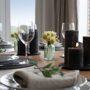 A dining table set with plates, glasses, and candles. - Family House With a Beautiful View in Damme (Bruges)