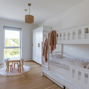 Enjoy a peaceful retreat with a bunk bed, large window, and dining area.
