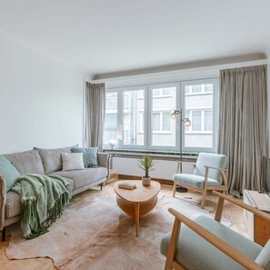 Relax in this stylish living room with a sofa, armchair, and coffee table.