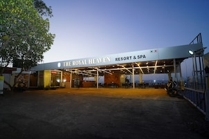 The Royal Heaven Resort & Spa with a covered entrance and outdoor seating area.