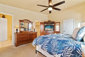 A bedroom with a bed, dresser, mirror, ceiling fan, and a door. - Bay Park Retreat with Backyard Fire Pit, Hot Tub, Ping Pong & Cornhole (San Diego)