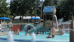 A water park with a large pool, slides, and a lookout tower. - Antler Ridge Cabin One (Murfreesboro)
