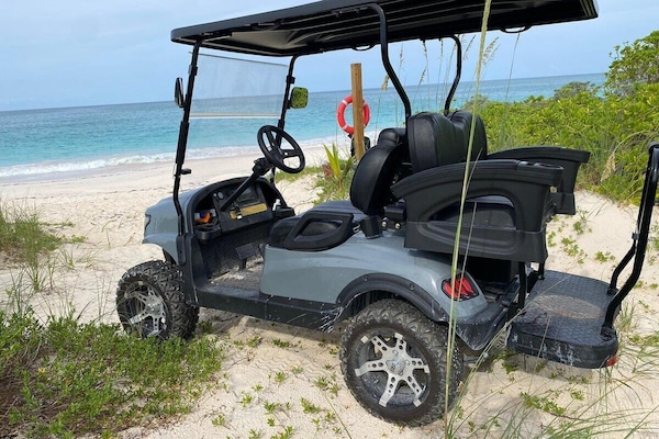 This beautiful new home comes with a golf cart for easy access around the private community of Wykee Estates, including our stunning mile-long beach, pictured here, and our lovely saltwater pool.