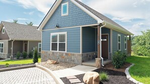 A two-story house with a stone foundation, a blue exterior, and a covered porch. - 5 Minutes From Dollywood/In DwTn Pigeon Forge (Pigeon Forge)