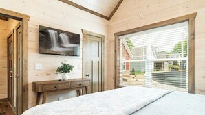 A bedroom with a large bed, a wooden desk, a TV mounted on the wall, and a window with blinds. - 5 Minutes From Dollywood/In DwTn Pigeon Forge (Pigeon Forge)