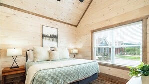 A bedroom with a bed, two bedside tables, a window with blinds, and a framed picture on the wall. - 5 Minutes From Dollywood/In DwTn Pigeon Forge (Pigeon Forge)