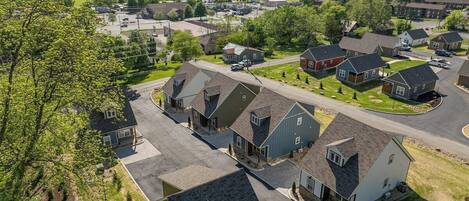 A residential area with houses, roads, and a parking lot.