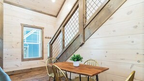 A wooden interior with a dining table and chairs, a staircase, and a window with blinds. - 5 Minutes From Dollywood/In DwTn Pigeon Forge (Pigeon Forge)
