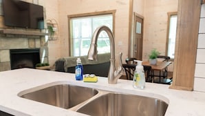 A kitchen with two stainless steel sinks, a marble countertop, and a built-in stove. - 5 Minutes From Dollywood/In DwTn Pigeon Forge (Pigeon Forge)