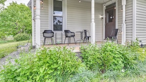 A porch with four black chairs, a table, and string lights. - Family Home w/ Yard & Fire Pit in Middleburgh! (Middleburgh)
