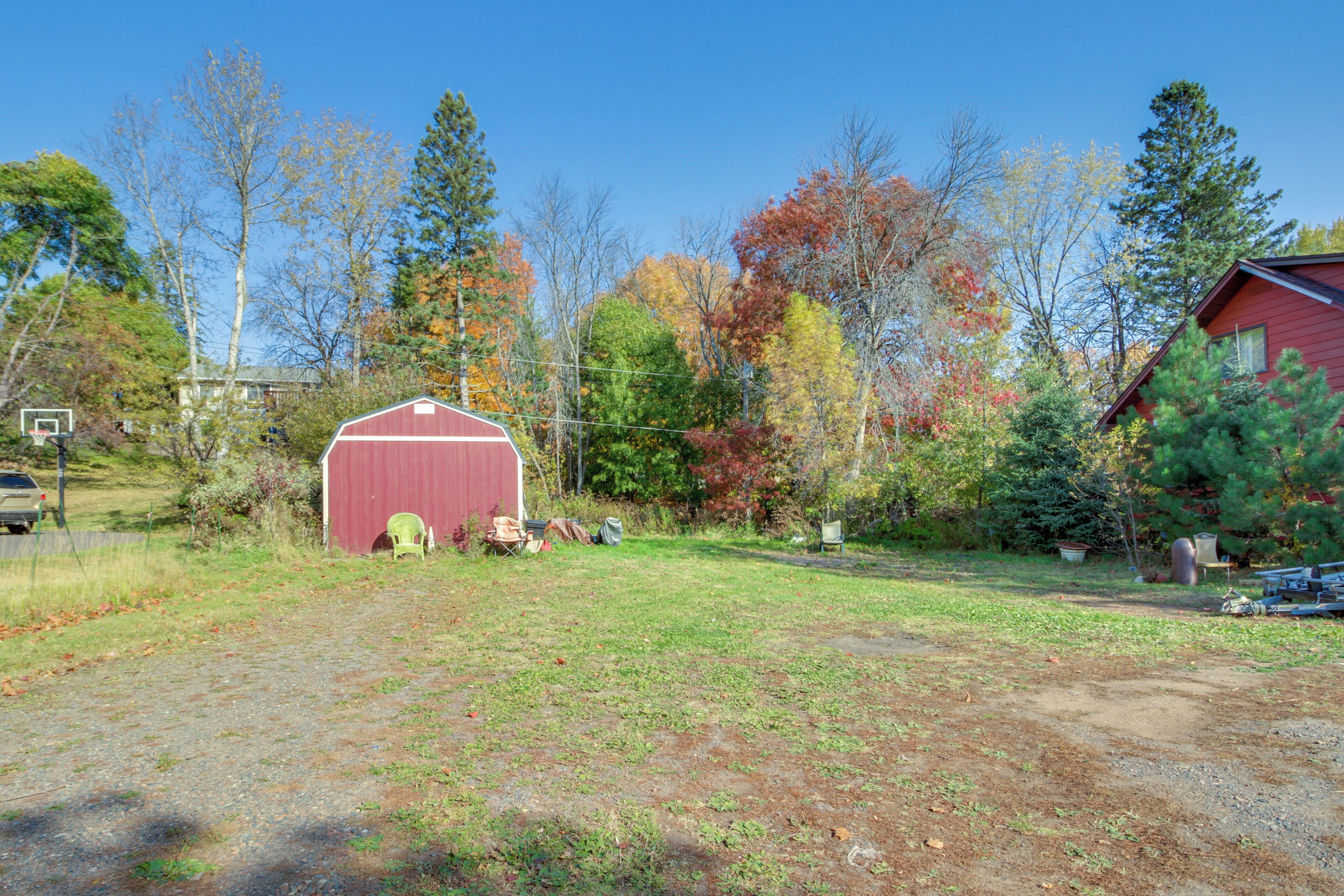 A red barn in a rural setting with a clear sky.