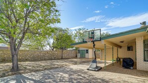 A basketball court with a hoop, a covered seating area, and a stone wall. - Pet-friendly El Paso Home ~ 9 Mi to Fort Bliss! (El Paso)