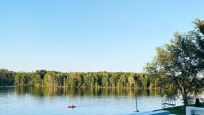 A deck with a view of a lake and trees. - [New!] Luxurious Lake Front Getaway!  (Wawaka)