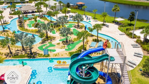 A resort with a large pool, water slides, and a golf course.