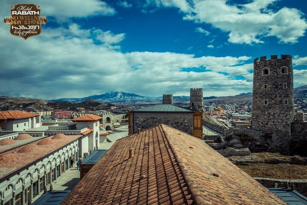 A view of a historic town with stone towers and a clear sky.