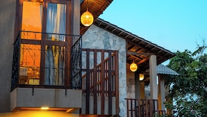 A building with a stone facade, a balcony with wrought iron railings, and hanging spherical light fixtures. - Pousada Brisas de Sagi (Baia Formosa)