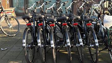 A row of bicycles parked on a paved surface.