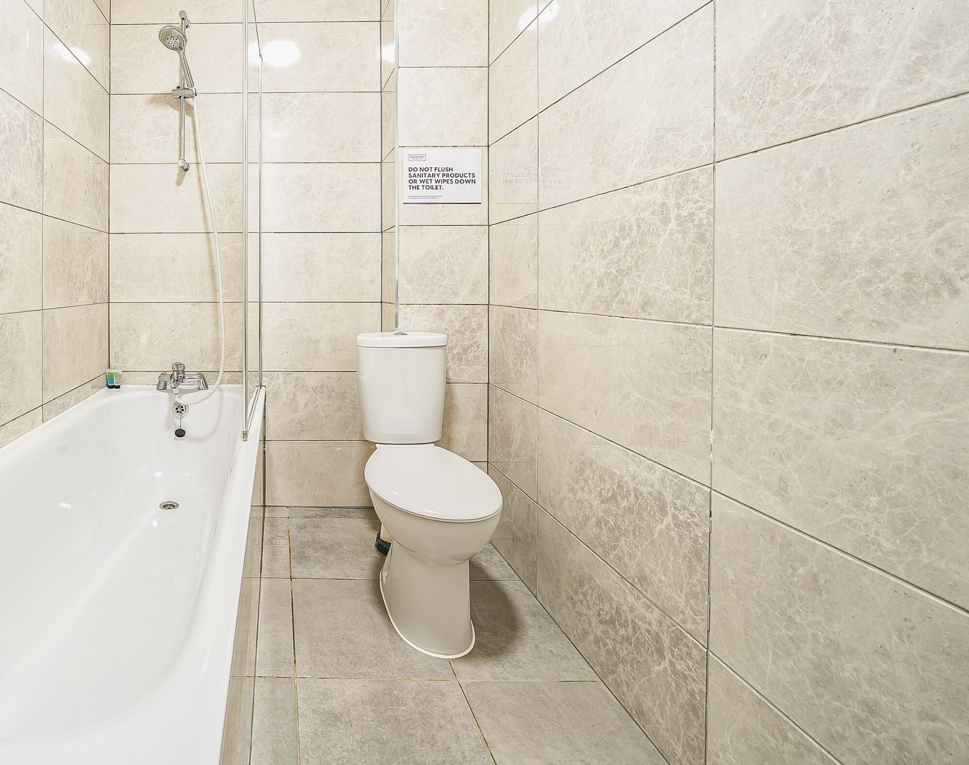 A bathroom with a bathtub, toilet, and a shower.