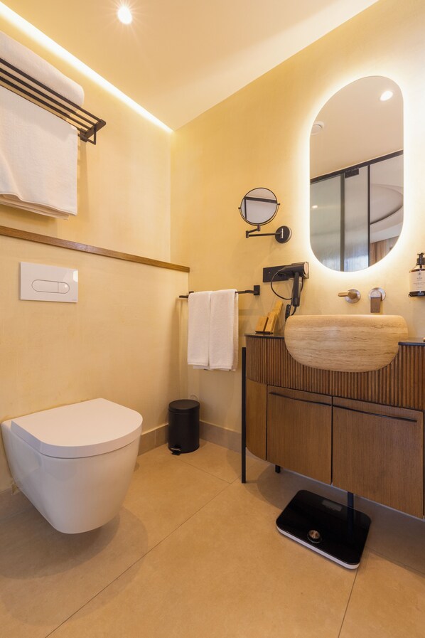 A modern bathroom with a toilet, sink, and mirror. - Le Square By Onomo Collection (Casablanca)