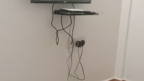 A flat-screen TV mounted on a wall with a cable management system.