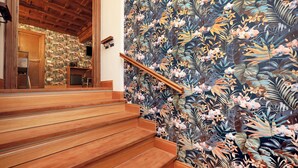A wooden staircase with a floral wallpaper mural on the adjacent wall. - Golden Pantheon Rooms (Rome)