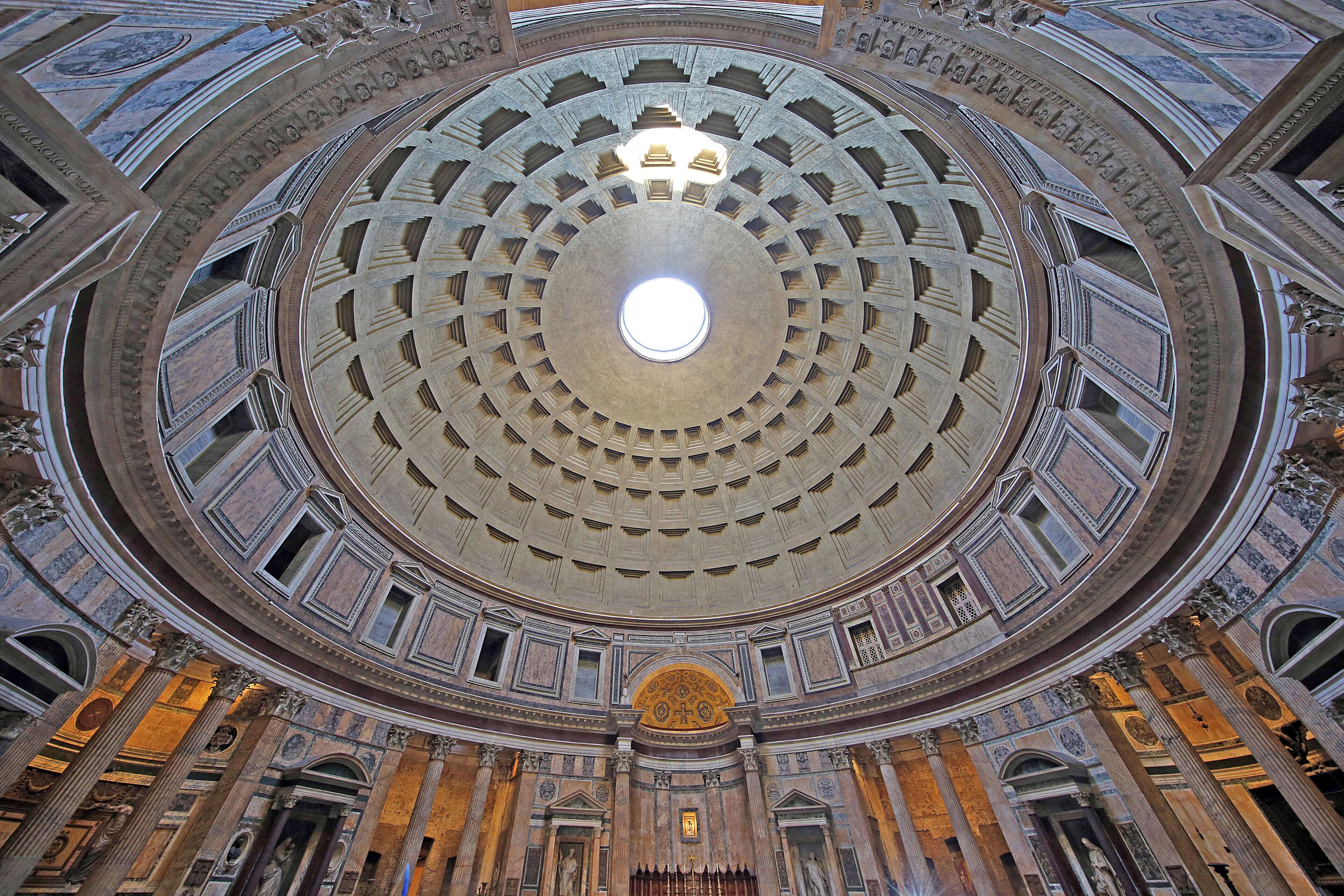 A grand architectural interior with a central dome, ornate columns, and detailed ceiling artwork.